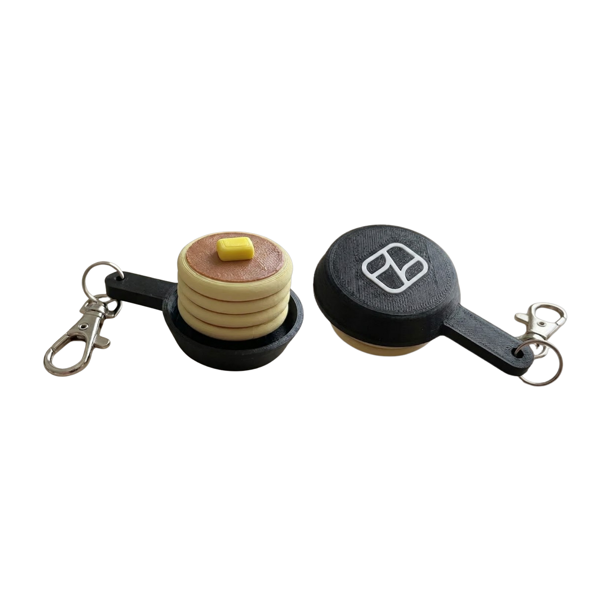 3D-printed pancake fidget clicker keychain, front and logo-on-pan views