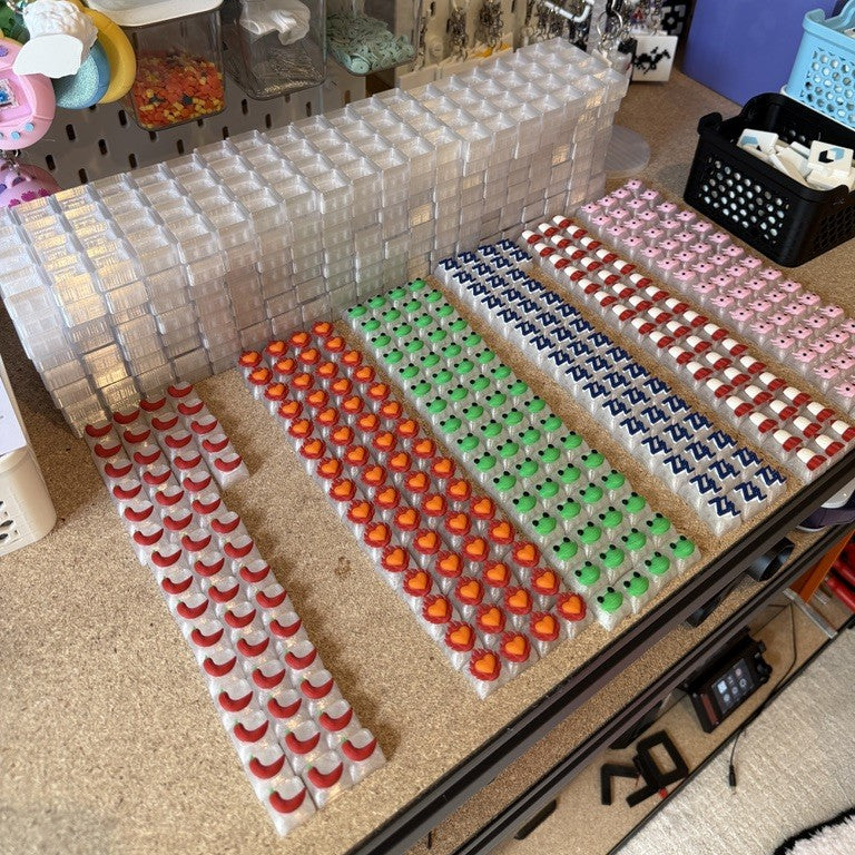 Custom logo keycaps and clicker cases sorted before assembly.Fidget Clicker Activation