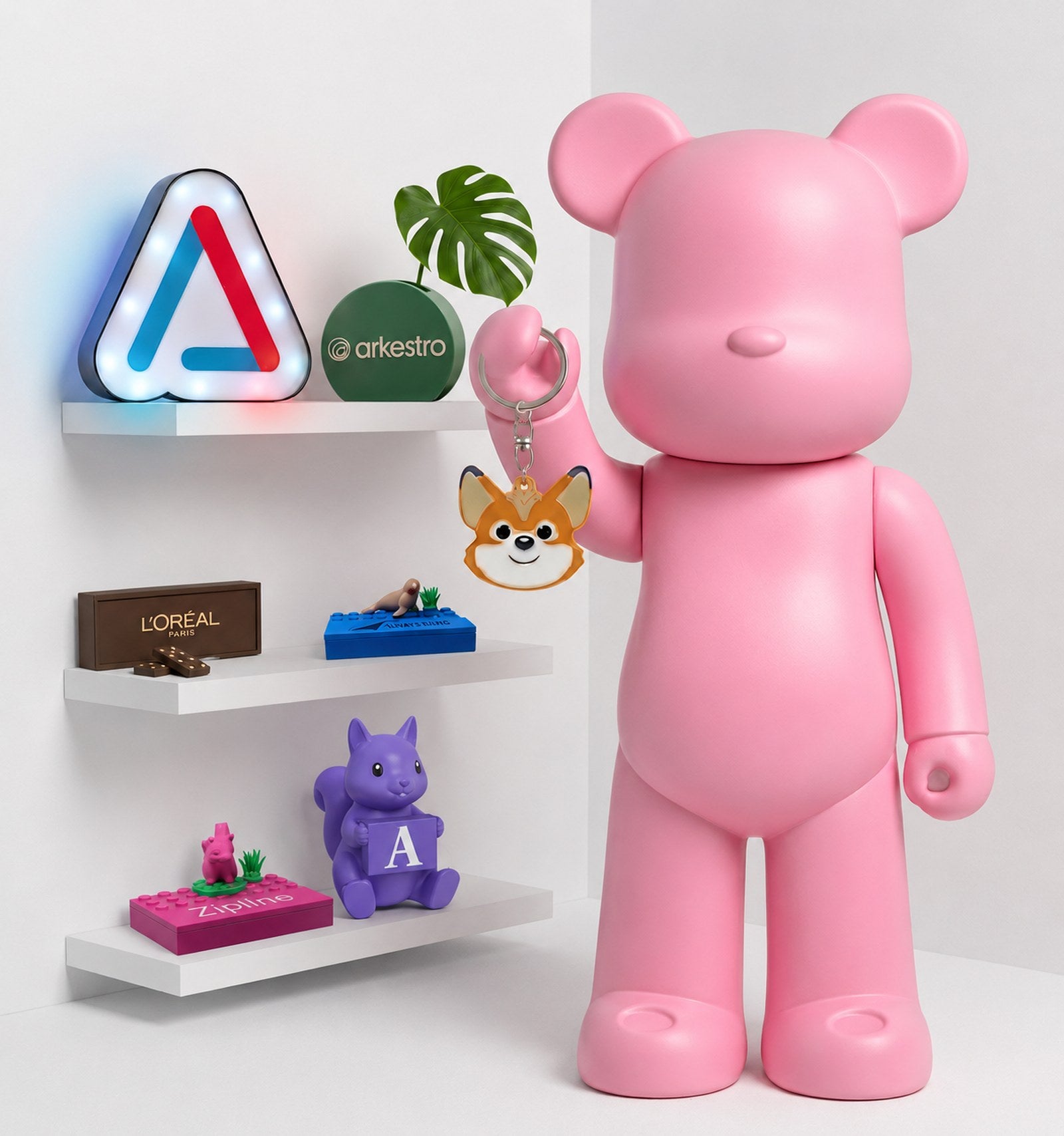 A collection of custom 3D printed branded swag: bear figures, NFC keychains, lightboxes, and more