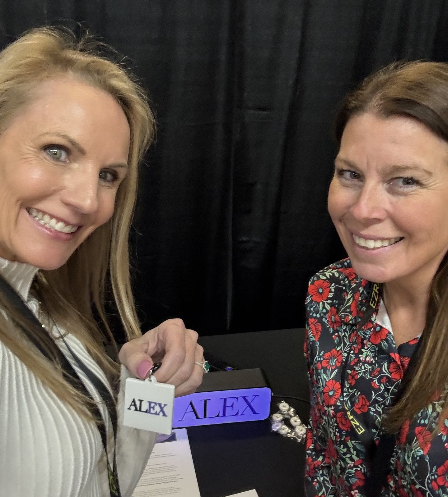 Custom 3D printed branded swag by The Bear Bar — portfolio example 114: Alex team at a conference with their custom NFC keychains and lightbox.