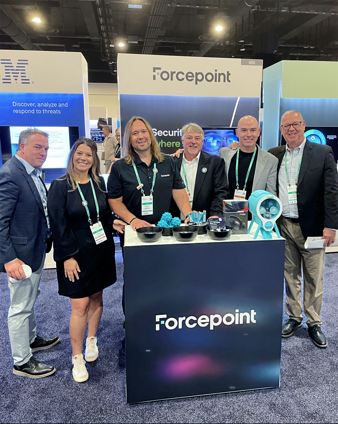 Custom 3D printed branded swag by The Bear Bar — portfolio example 117: Forcepoint team at their conference booth with a custom branded capsule machine activation.